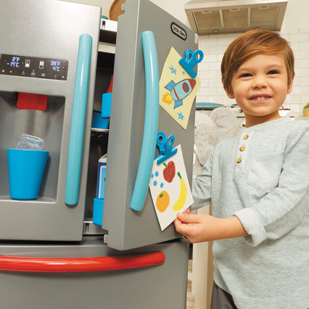 First Fridge - 
Kids can display grocery lists, art, and photos using the clips on fridge door.
