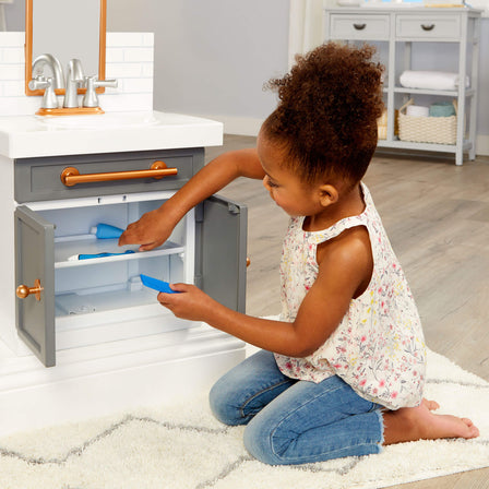 First Bathroom Sink - 
Store accessories under sink for easy cleanup during or after play.