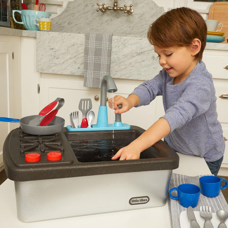 First Sink & Stove - 
Pushing down on the built-in water pump sends water flowing through the faucet.